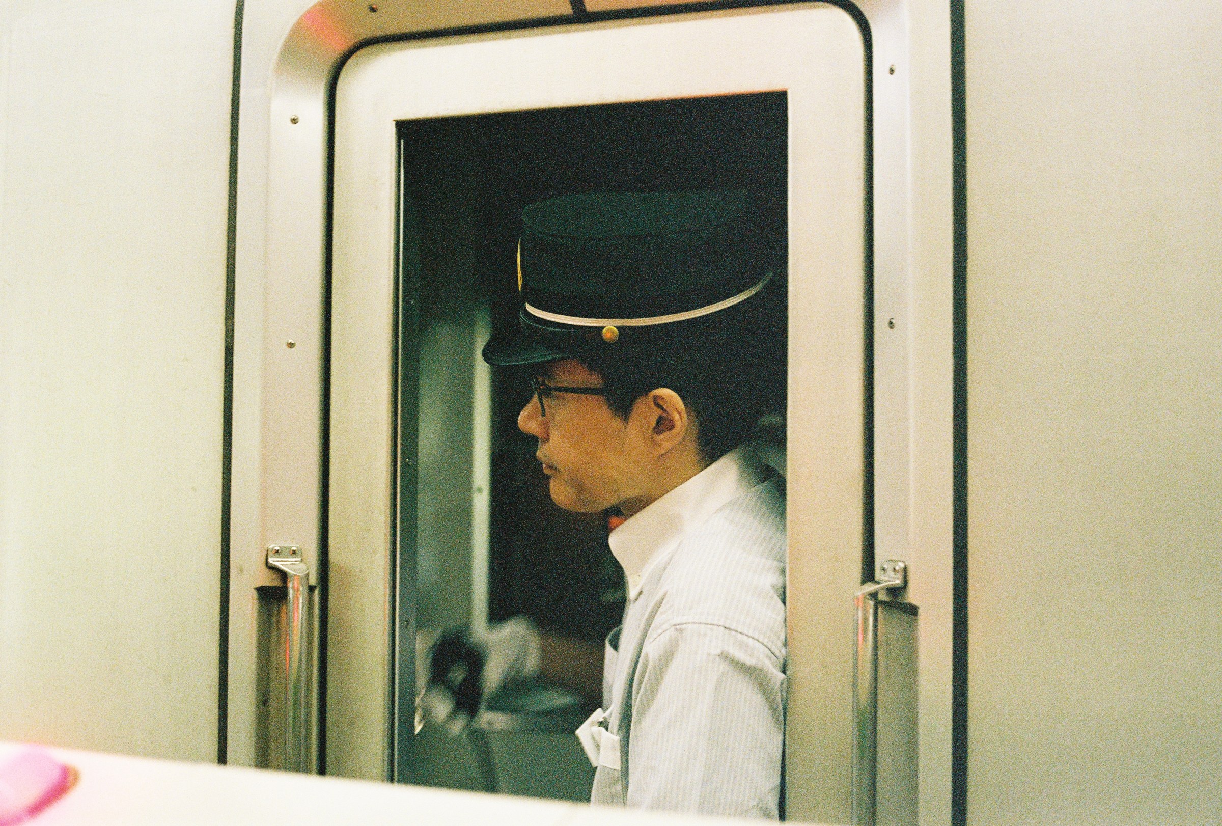 A train conductor waiting for passengers.