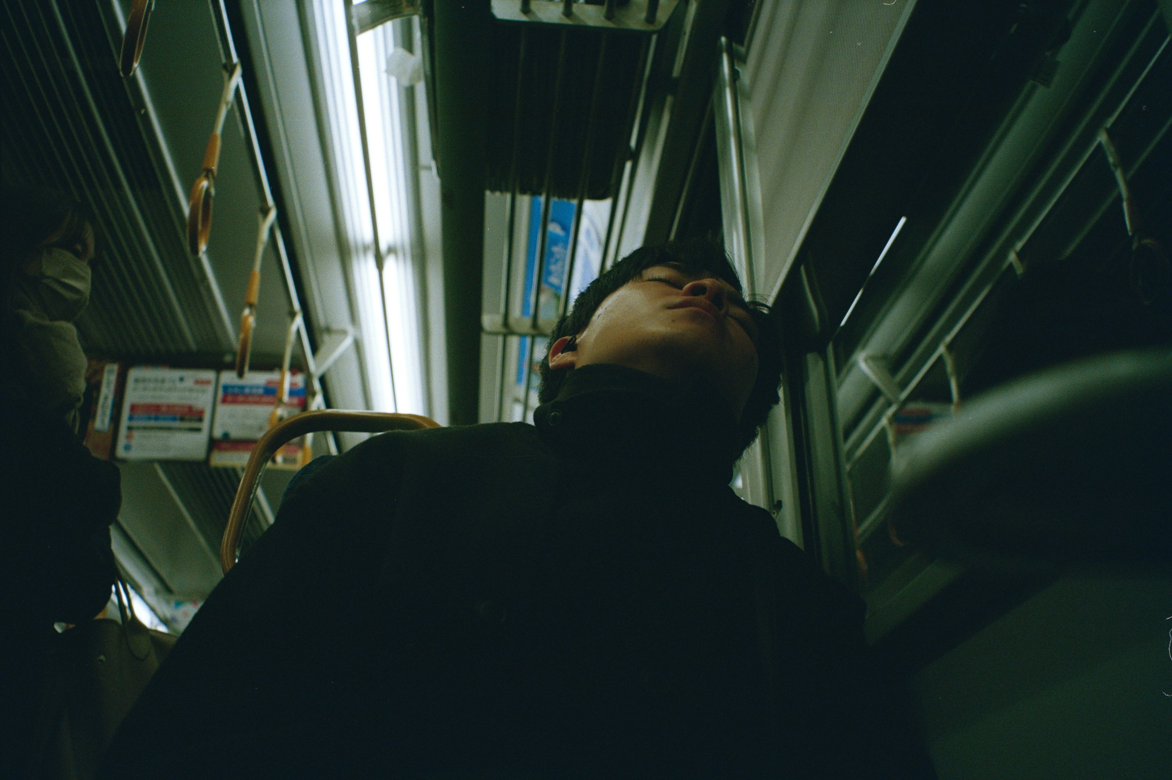 A man sleeping on the metro.